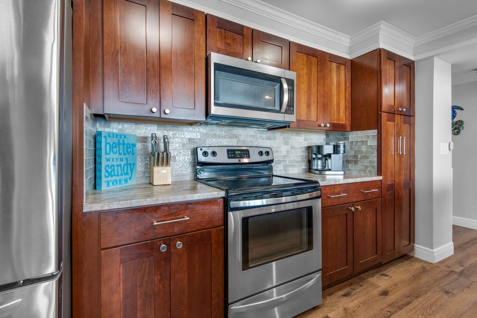 Kitchen with glass top range and new refrigerator