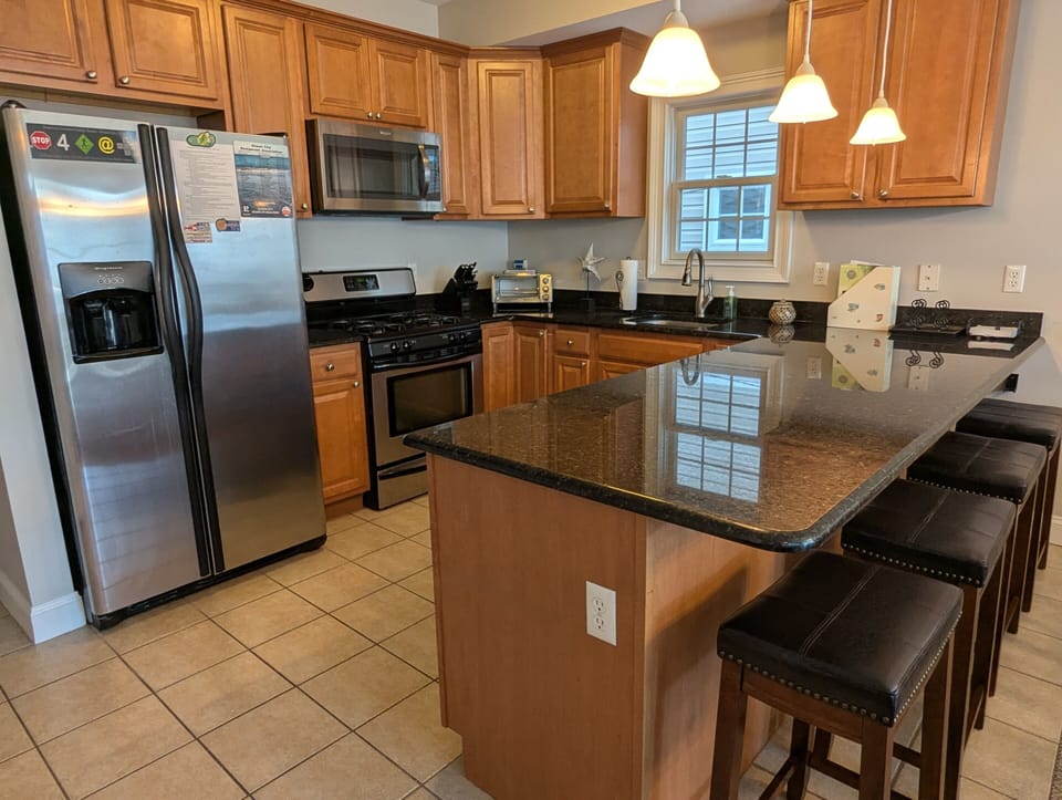 Beautiful modern kitchen with huge island and stainless steel appliances.