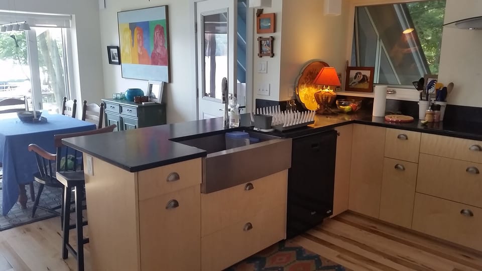 The cook's kitchen features a farmhouse sink, dishwasher and soapstone counters.