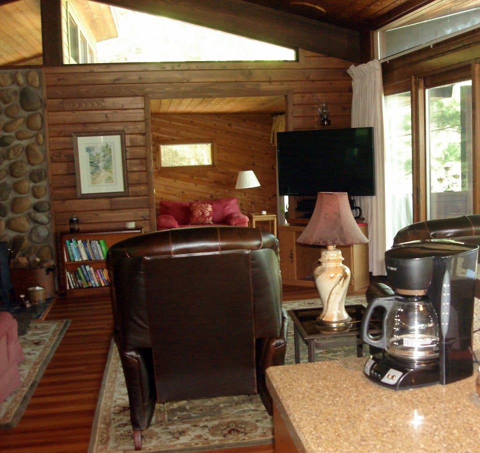The great room opens off the kitchen and leads to the screened porch