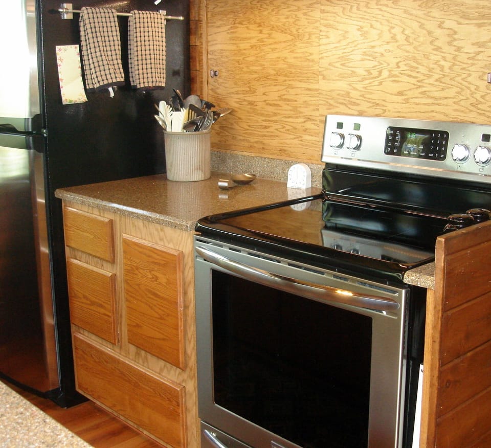 Kitchen features conduction range & fridge with ice maker, spices & condiments