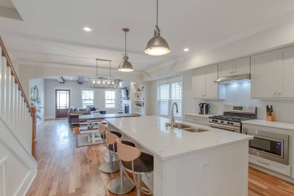 A wide view of the main floor shows the kitchen, dining, and living areas connected beautifully.