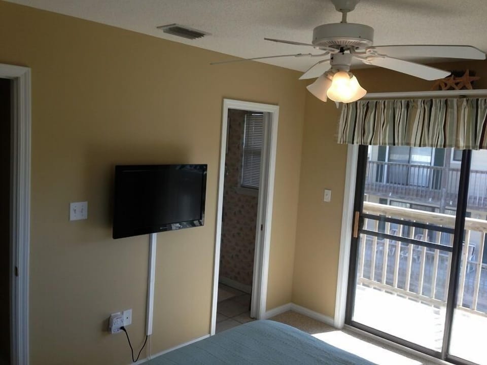 Bedroom 2 with TV, private full bathroom, and direct access to upper deck