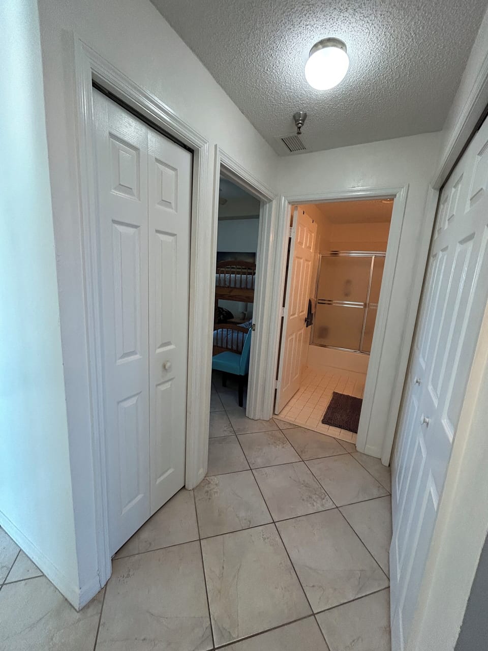 Hallway to washer/dryer closet, second bedroom, and bathroom