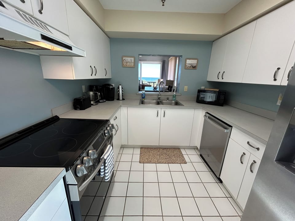 Kitchen with window to living room.