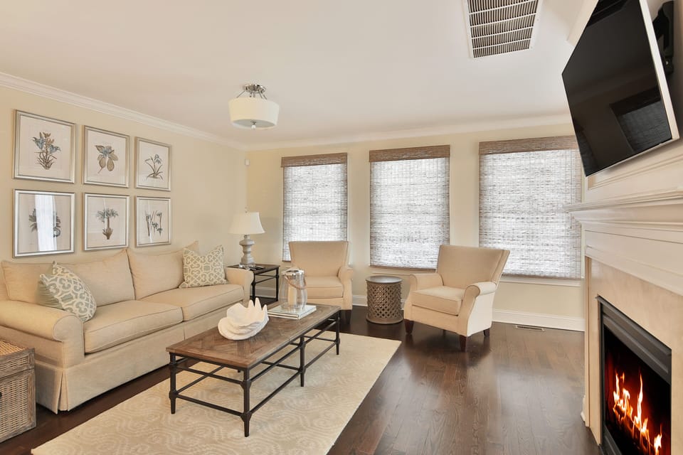 living room is light and airy - beautiful hardwood floors - TV and gas fireplace