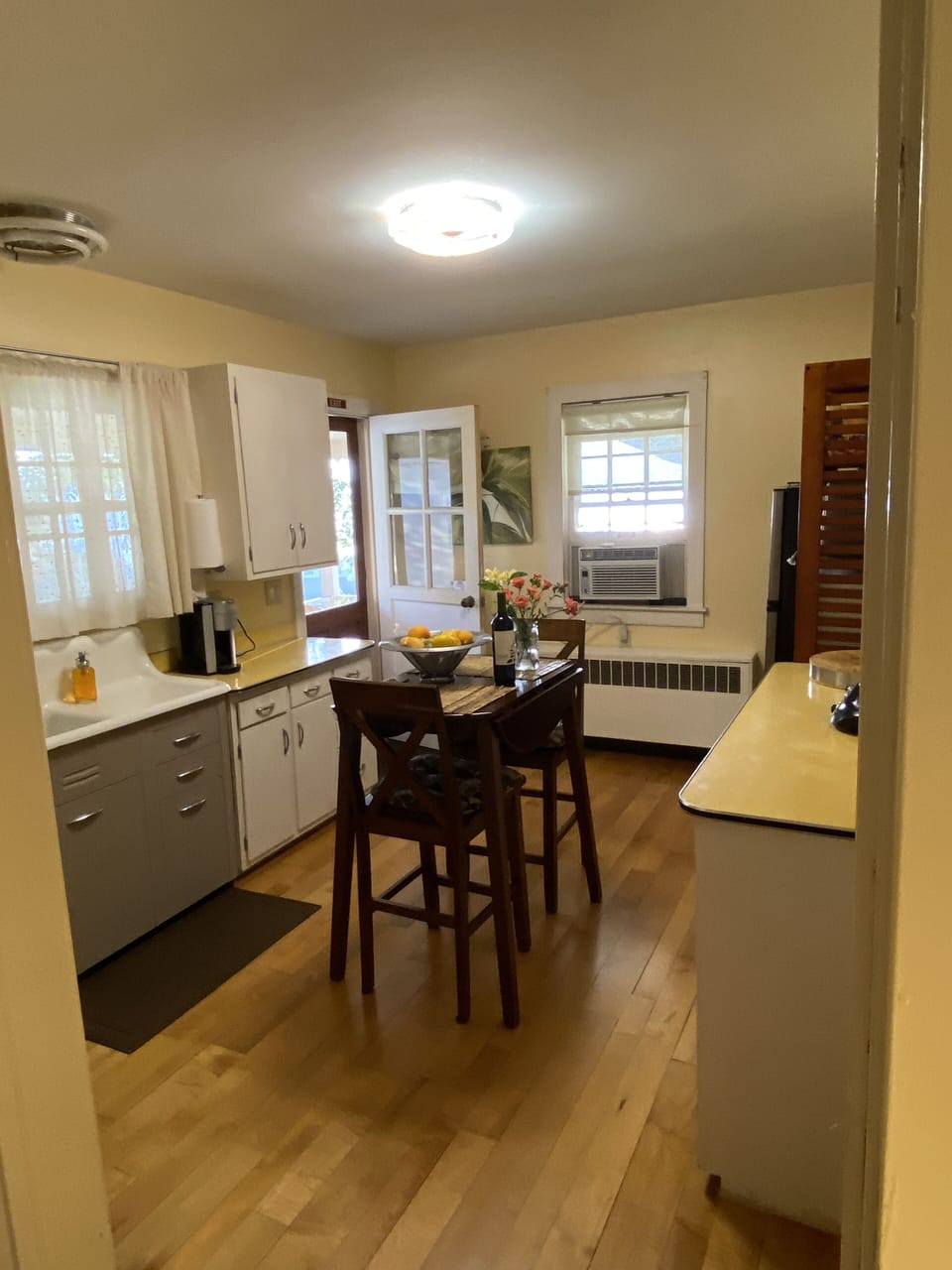 Kitchen with refrigerator/Toaster Oven/Microwave/Hot Plate. 