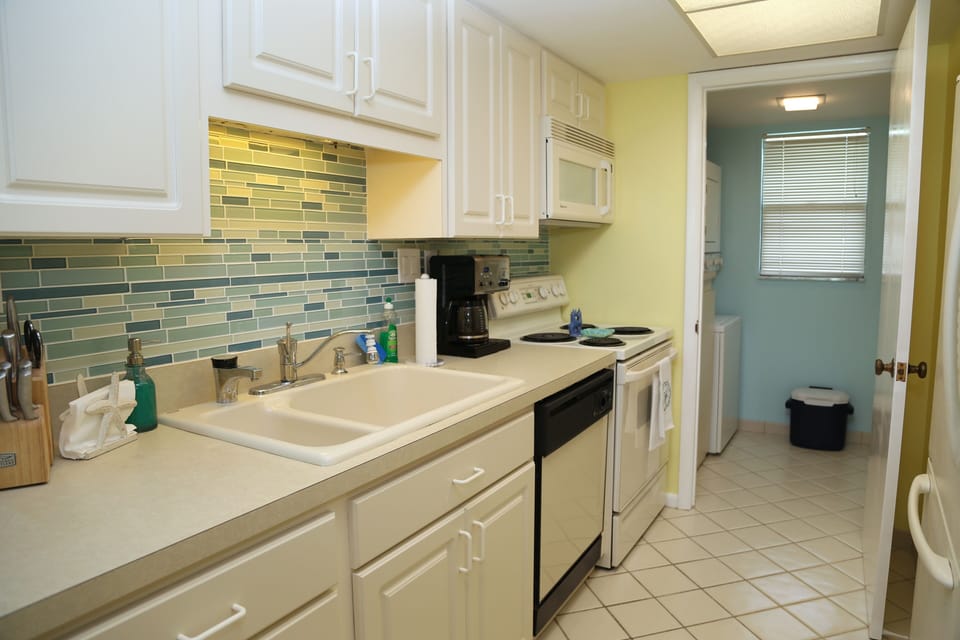 Fully stocked Kitchen with access to the laundry room with washer and dryer.