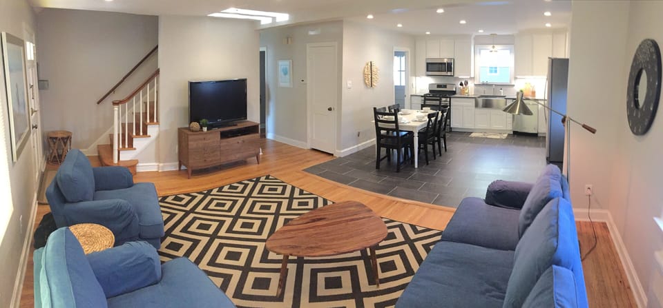 Panoramic view of kitchen, dining, and living area