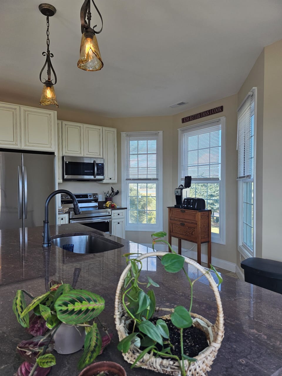 Kitchen w/ Samsung Electric Range, Microwave, and Oversized Refrigerator.