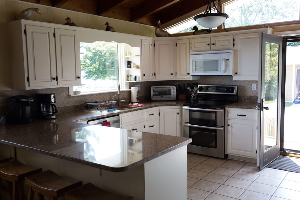 Updated kitchen with granite countertops and stainless steel appliances