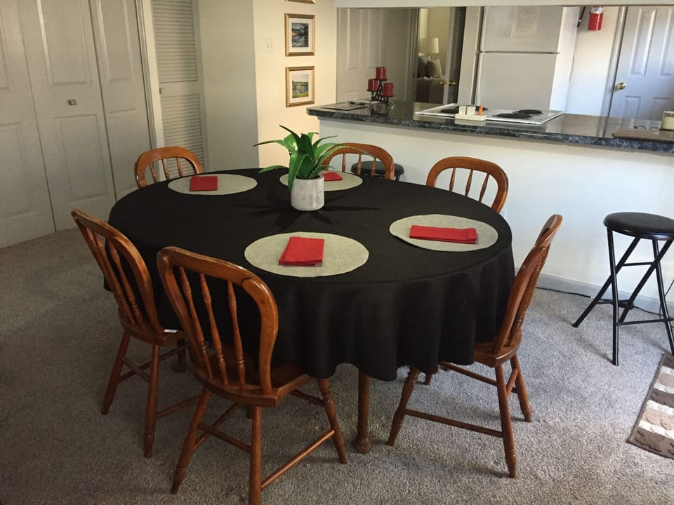 Dining table, extra leaves in laundry closet.
