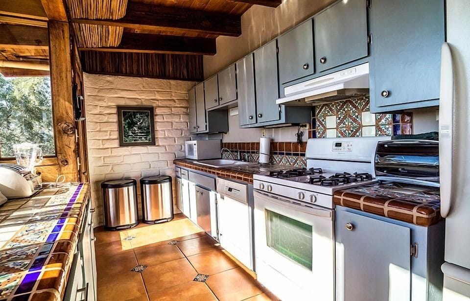 Fully equipped galley style kitchen with mountain views.