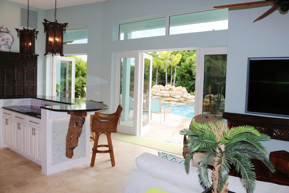 The cool ocean breeze gently blows over the resort pool and into the house.