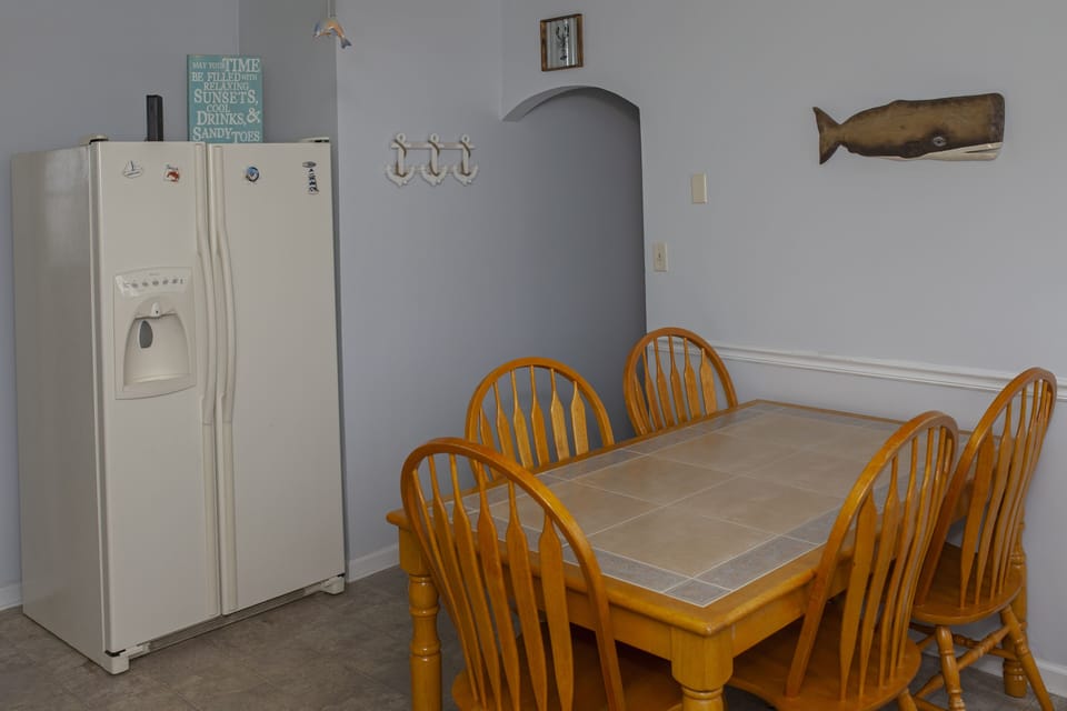 Kitchen - large refrigerator and large table 