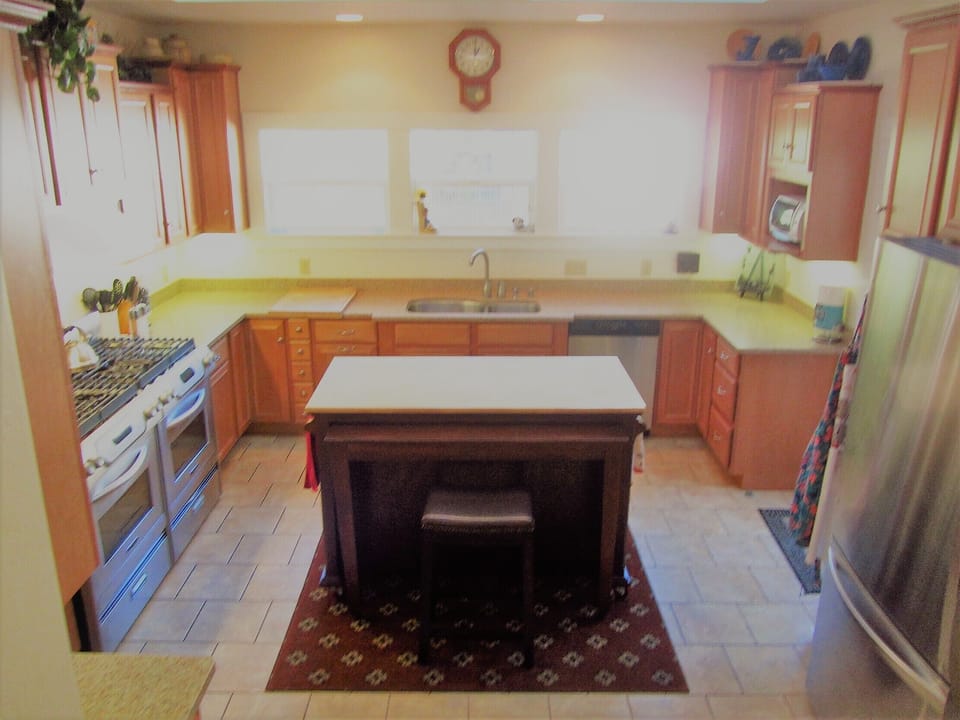 Kitchen has 2 stoves 2 dishwashers and 2 Frigs