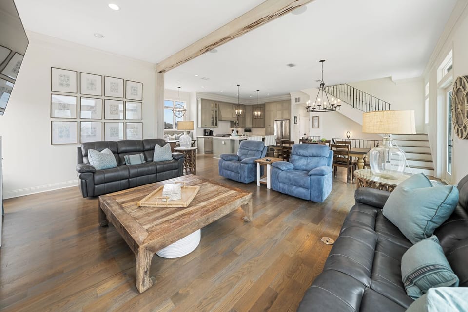Settle into your spacious living room with comfortable leather seating and rustic wood accents, perfectly connected to the chef's kitchen.