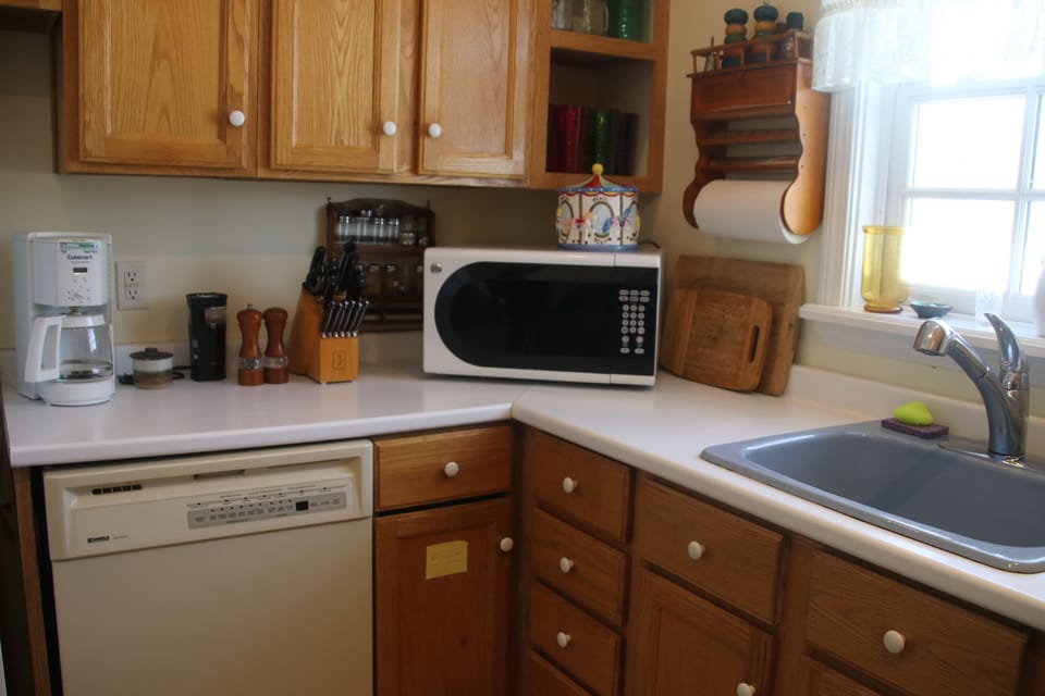 Another view of kitchen with d/w, full complement of pots, pans, dishes, etc.
