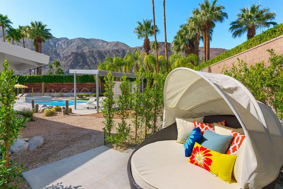 Covered cabana bed for private lounging alongside the citrus grove