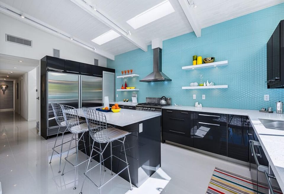 Gourmet kitchen with stainless appliances, quartz counters & European cabinets