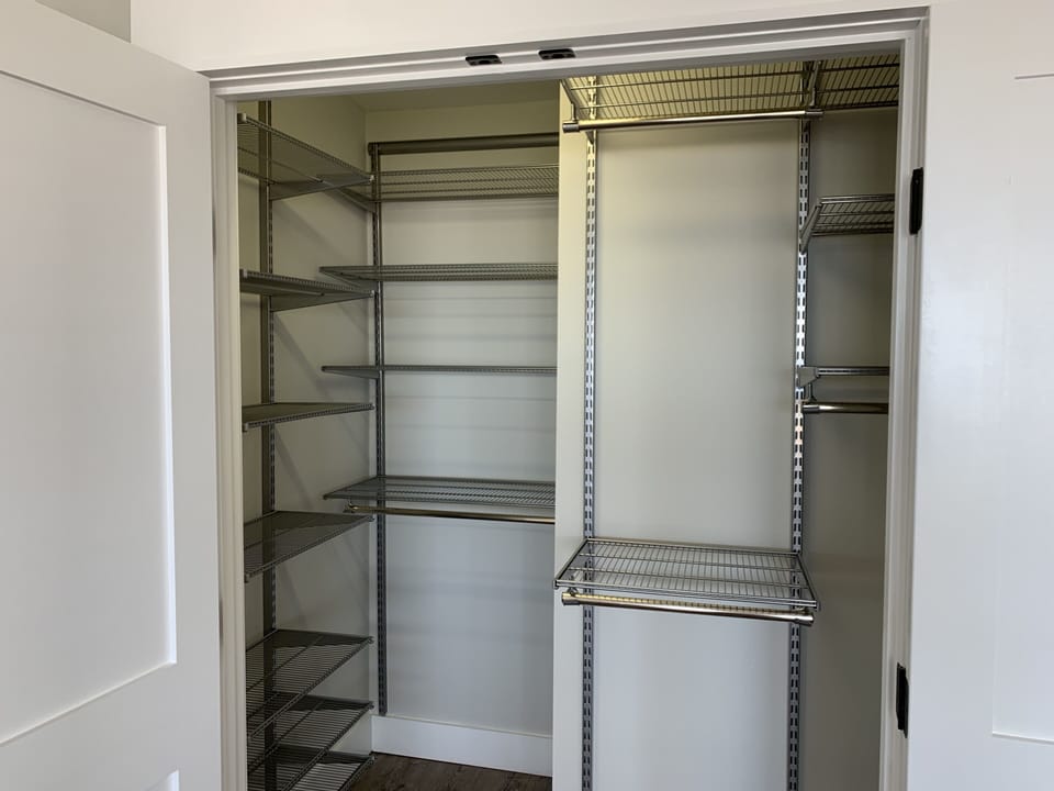 Elfa Shelving in Main Floor King Suite Closet