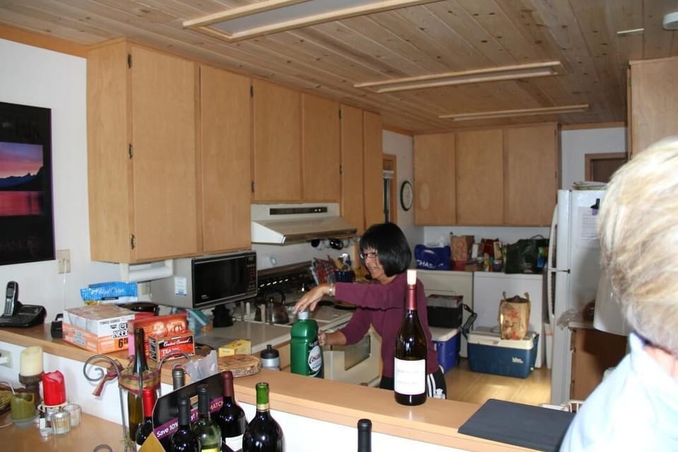The kitchen is the fourth space on the main floor, seen from the dining room.