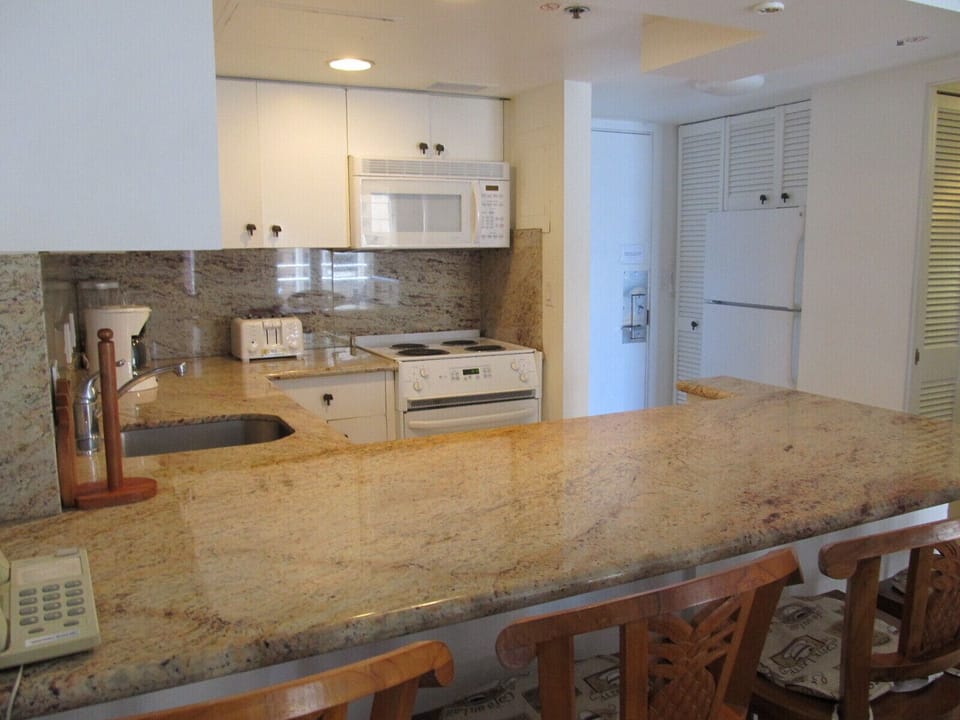 Kitchen with full size refrigerator.