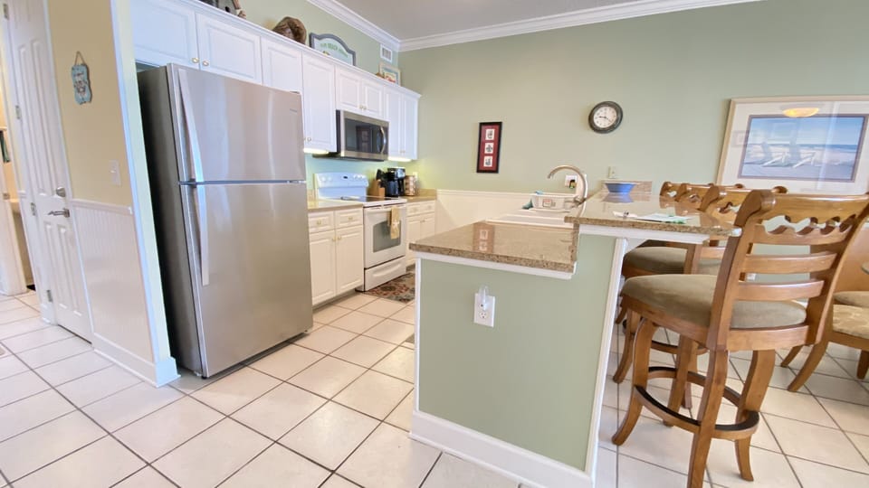The full size kitchen has granite counters and two coffee machines.