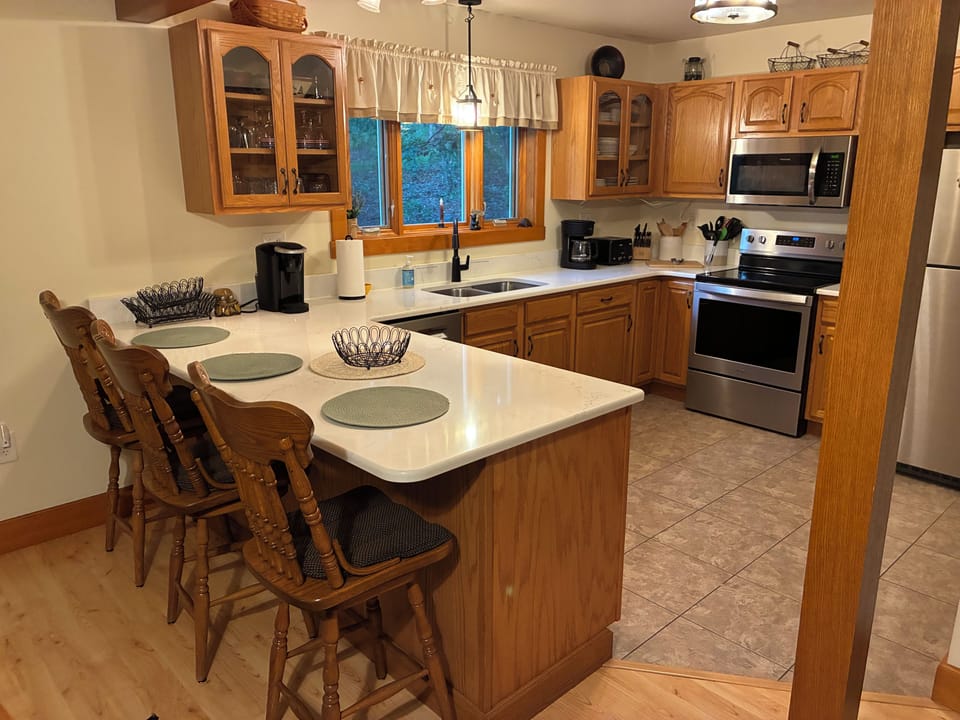 Kitchen w quartz counters and most all cooking utensils.  