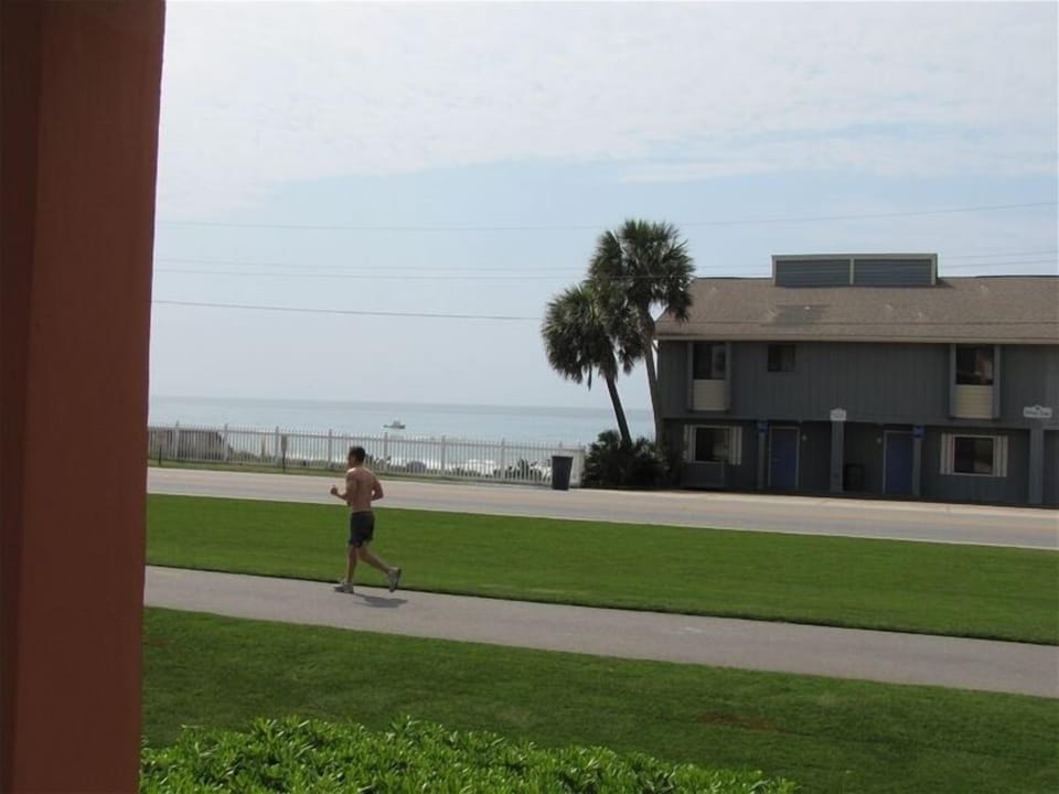 Standing on the balcony looking at the ocean. Jog or cycle the trail out front.