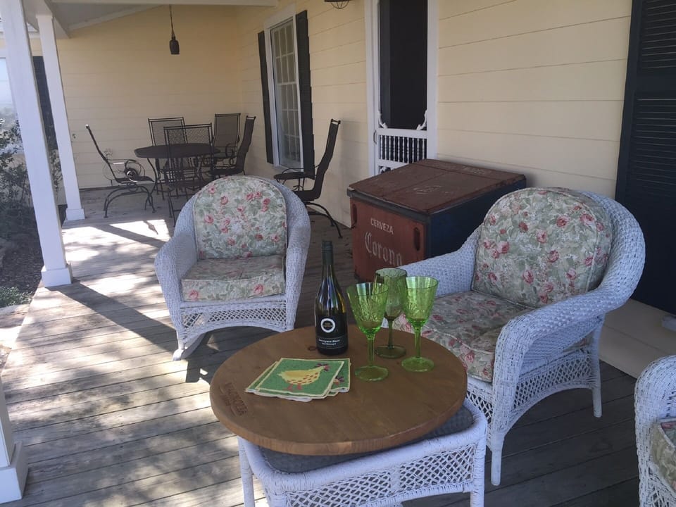 Side porch with seating area and dining table.