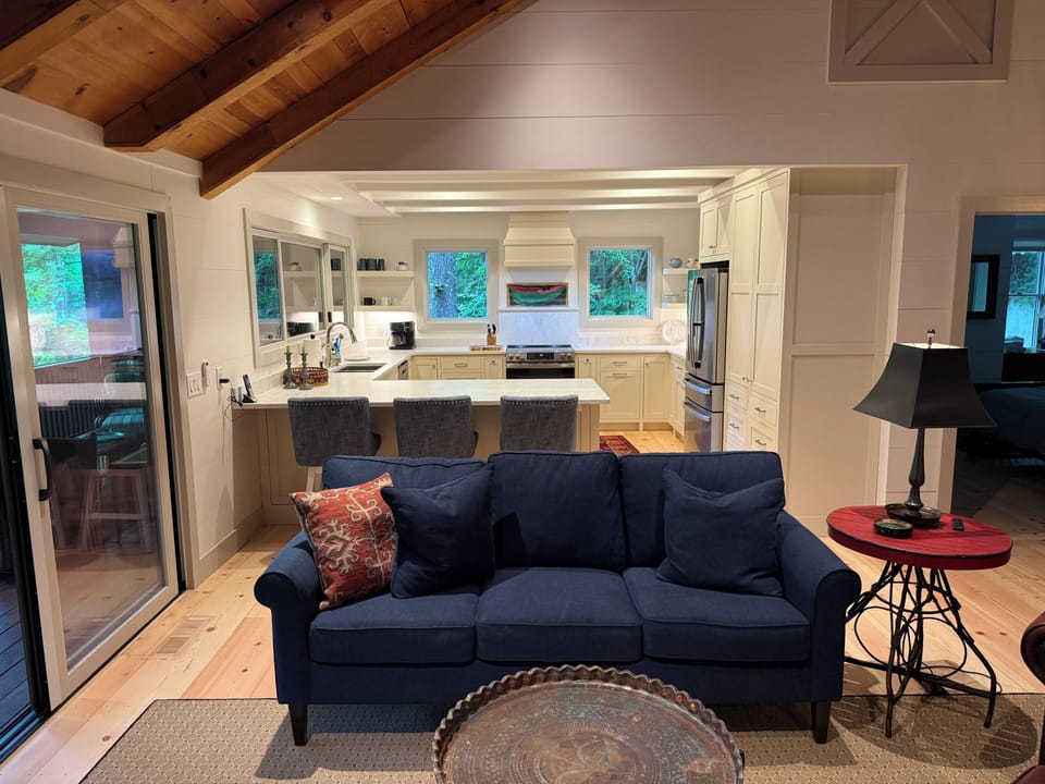 Open kitchen with three counter stools. 