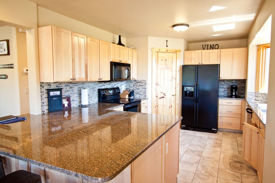 Remodeled kitchen with granite counter tops and breakfast bar
