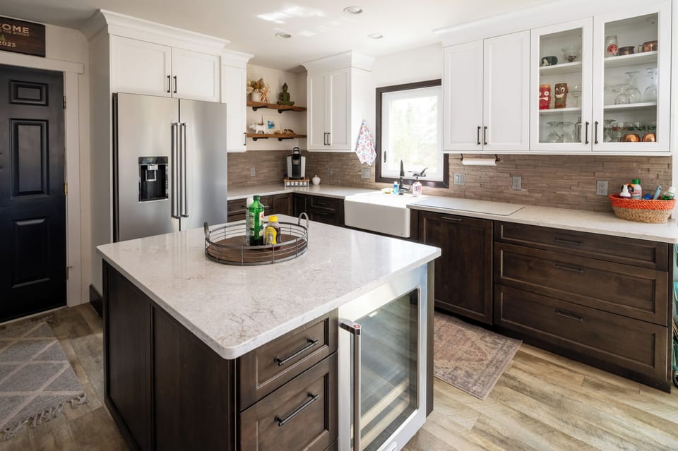 Bright modern kitchen with quartz island, farmhouse sink & beverage fridge