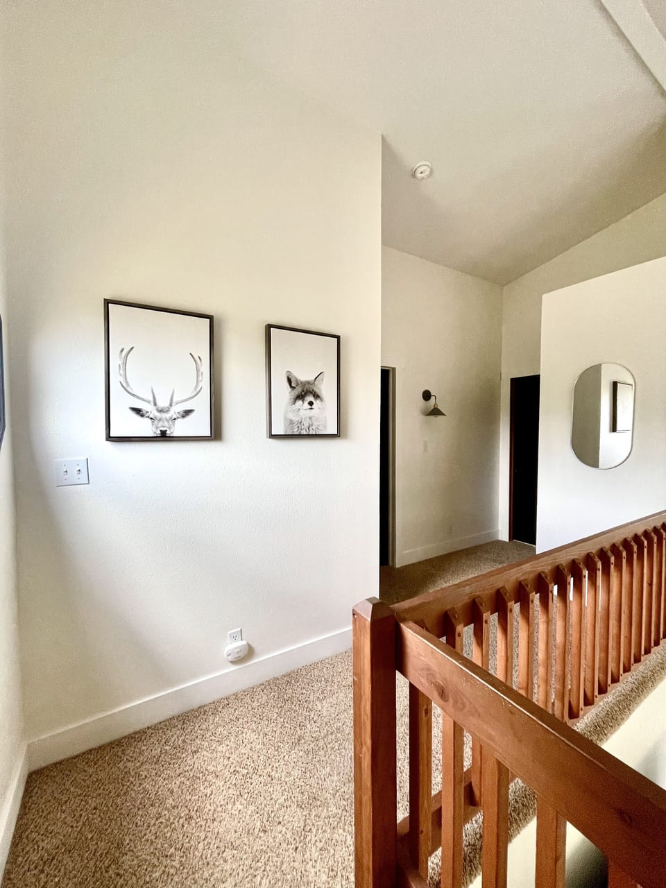 Upstairs corridor leading to primary bedroom, guest bedroom, and connecting bath