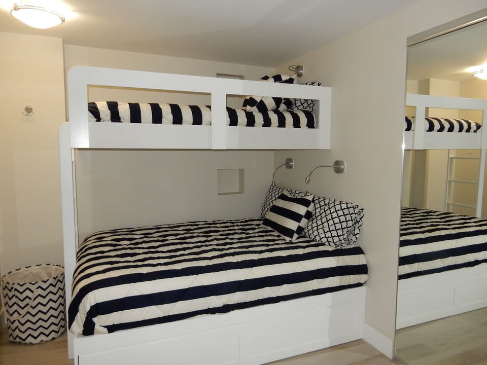 Den with Queen bed, twin and trundle.  Nooks include outlets for charging
