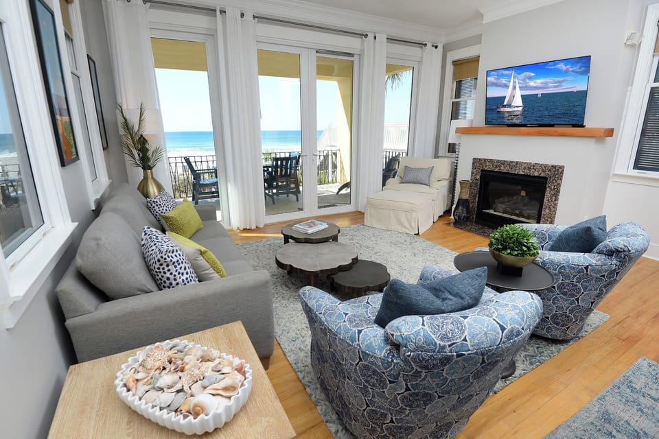 Bright coastal living room with expansive Gulf views and plenty of space for fam