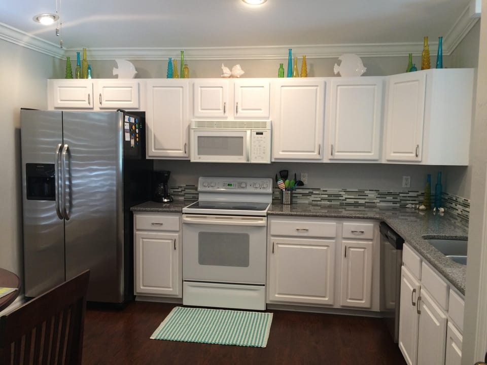 Updated kitchen with Quartz countertops & well stocked with everything you need!
