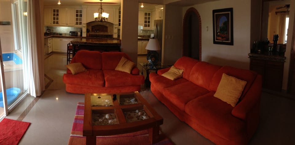 Living room and kitchen with jacuzzi visible on left