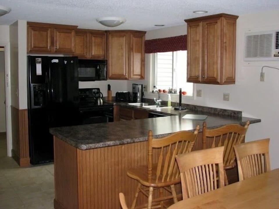 Fully equipped kitchen with ice maker and water dispenser.