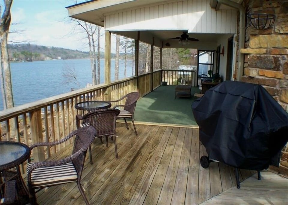 Large deck at side of house with lake views.