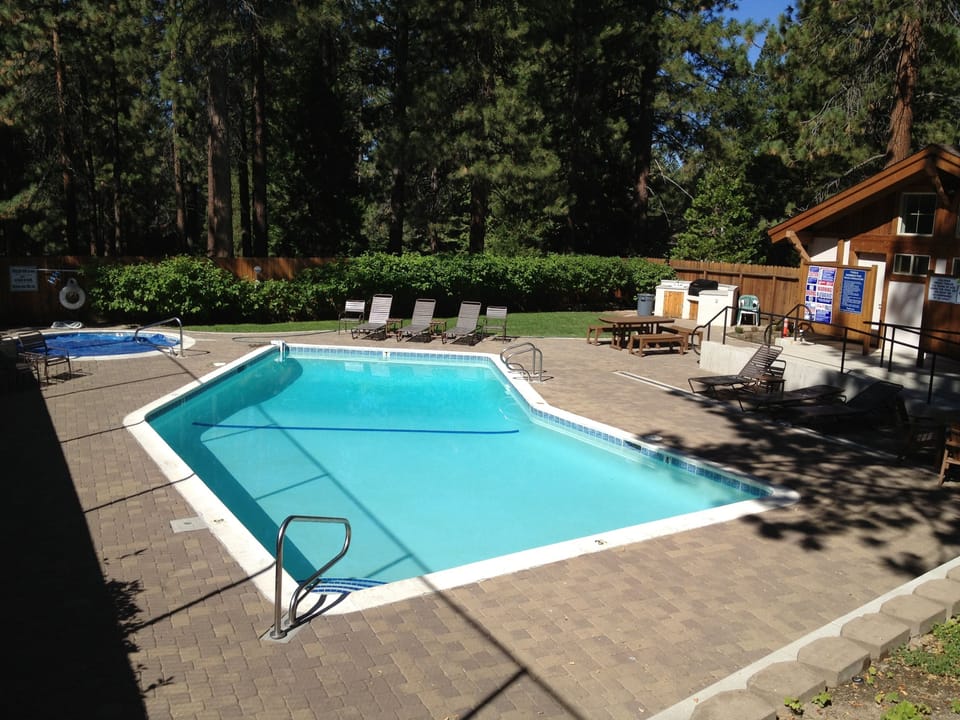 Heated community pool, hot tub, and charcoal BBQ.