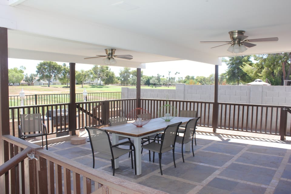 Large covered patio with a view overlooking the golf course