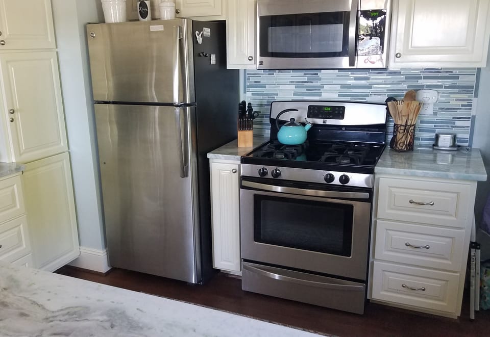 Gas cook stove. Microwave and fridge.  Fully furnished modern kitchen. 