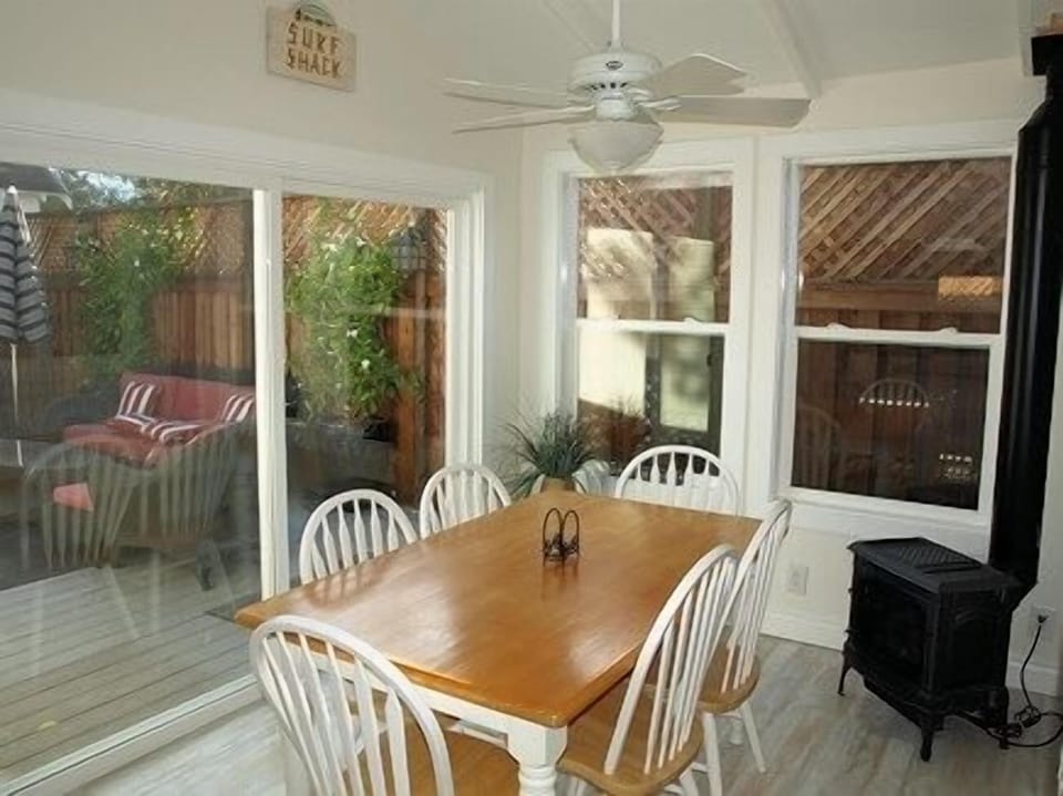 Kitchen dining area with gas fireplace, opens to backyard