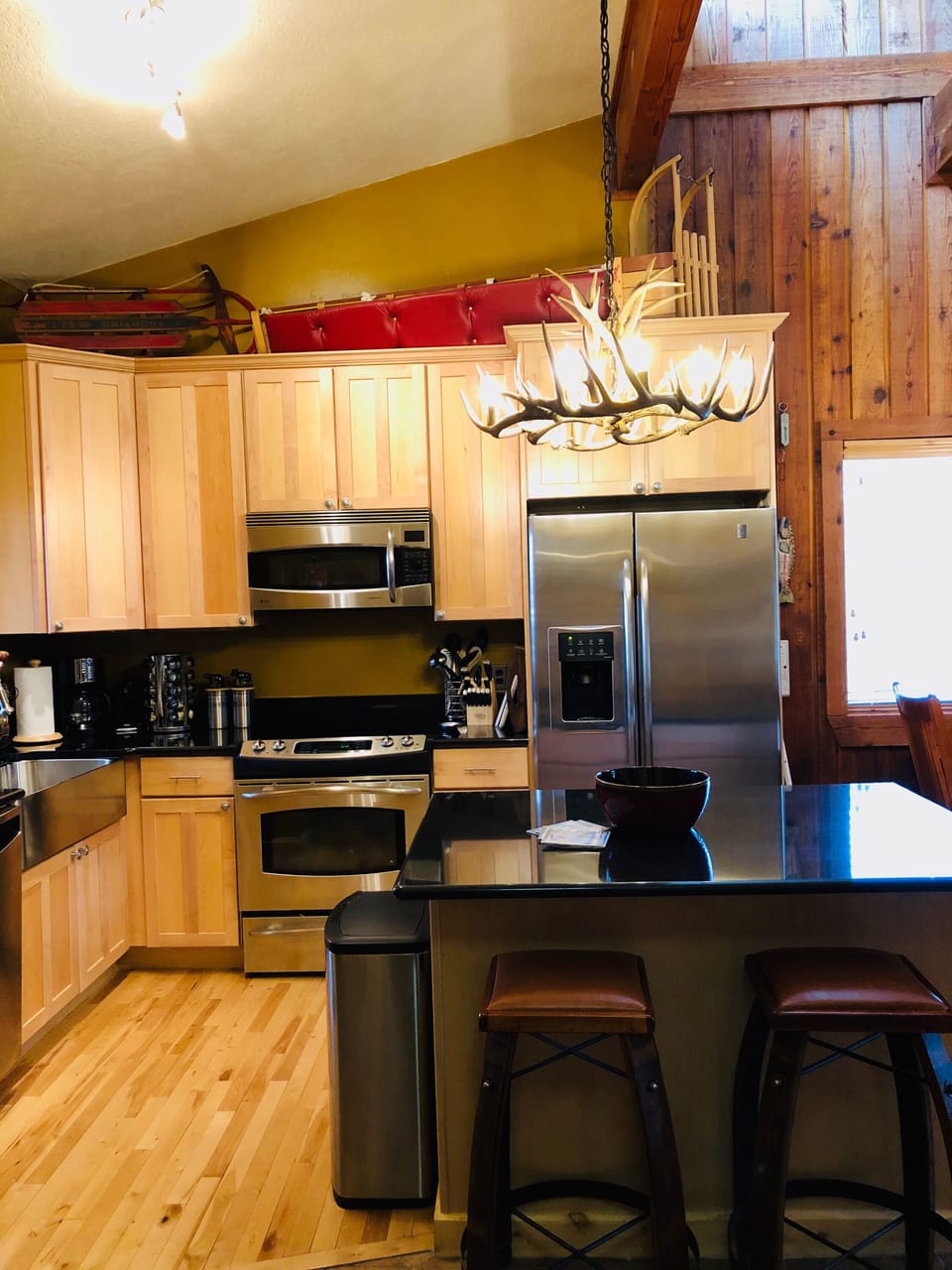 Kitchen with hard wood floors, updated stainless steel appliances & wine  cooler
