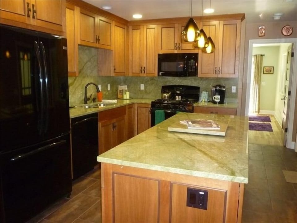 Kitchen with unique granite countertops and backsplash as all the amentities.