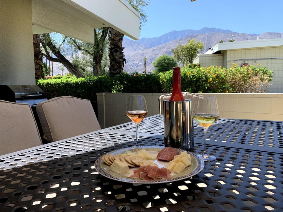 Enjoy happy hour on the private patio under the umbrella.
