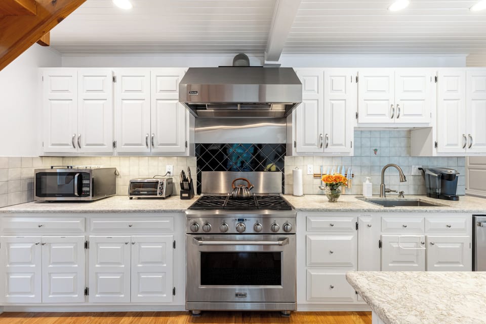 Six burner gas cooktop/range; microwave; toaster oven; Keurig coffee maker.