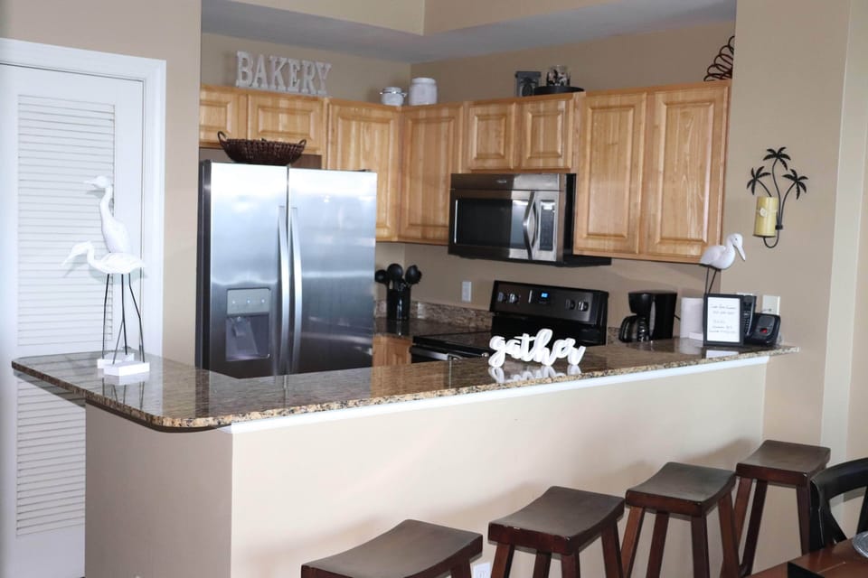 Fully stocked kitchen with bar seating